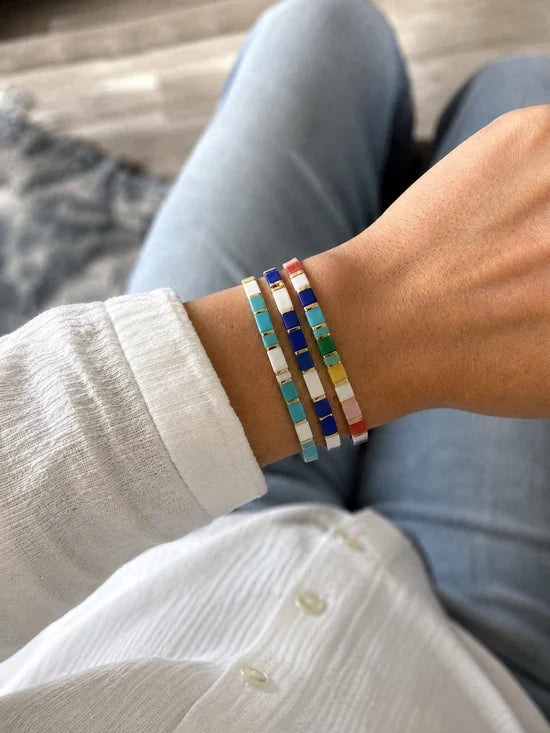 Customer photo: three colorful Miyuki glass tile bracelets worn stacked on a wrist